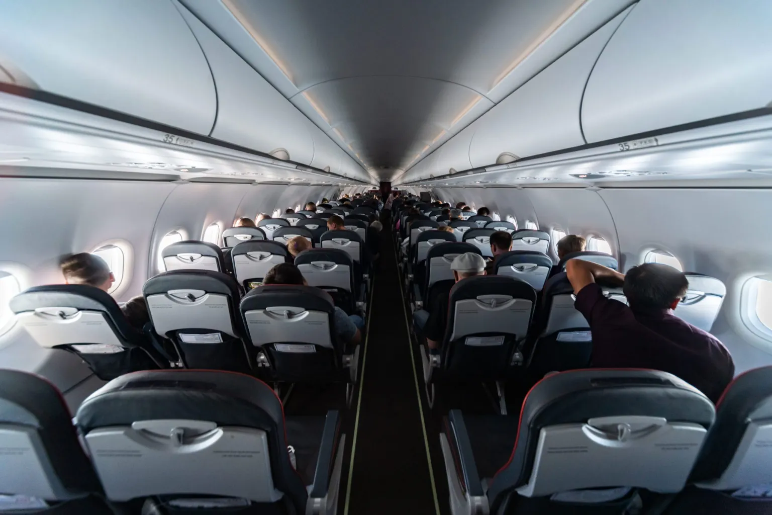 airplane-cabin-seats-with-passengers-2021-08-30-22-09-31-utc-scaled